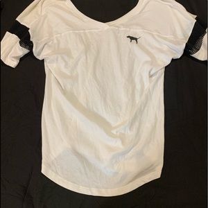Mainly white shirt with black material in certain spots.